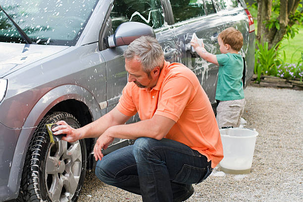 istock Father and son washing car 155421147