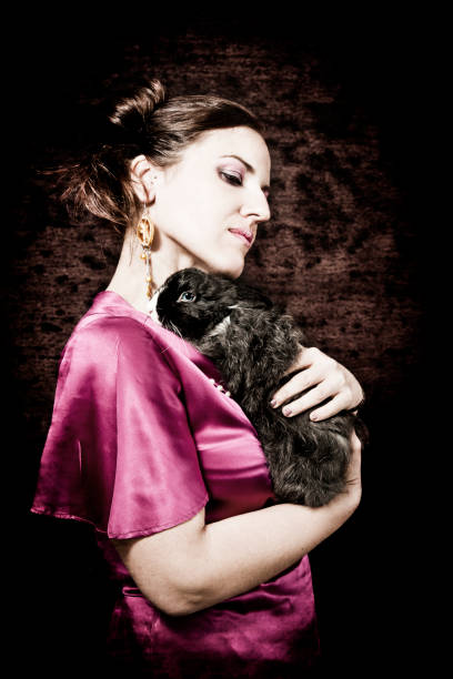 istock Pensive woman holding a rabbit 155421192