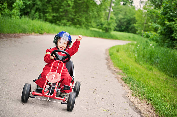 Race winner Little boy winning a go-kart race.  soapbox cart stock pictures, royalty-free photos & images