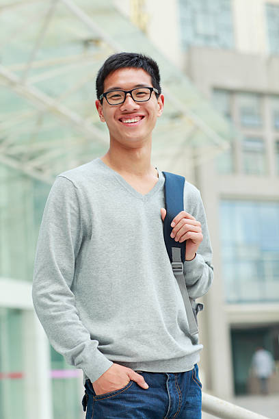 istock portrait of young college student looking at camera smile 155421456