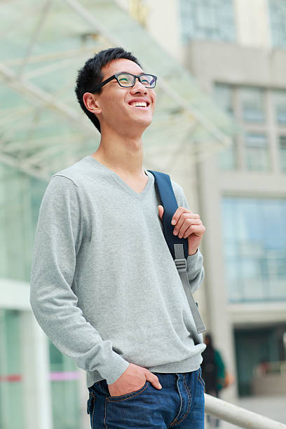 istock portrait of happy young asian man with backpack 155421457