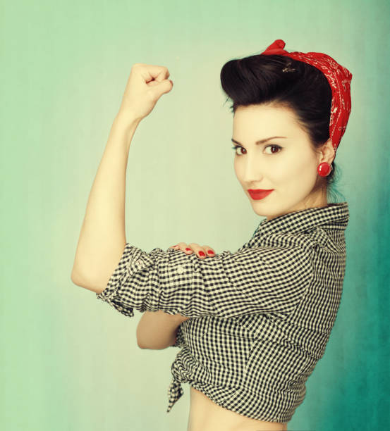 Famous retro Rosie Riveter pose poster  rolled up sleeves stock pictures, royalty-free photos & images