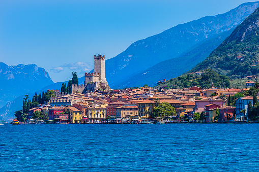 Beautiful image of Malcesine, one of the most visited and fascinating places on the shores of Lake Garda, the largest Italian lake. Its charming historic centre has narrow stone-paved alleys that climb towards the castle situated on a rocky outcrop overlooking the lake.