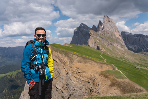 Portrait of an male Caucasian hiker in front of the Alpe di Seceda