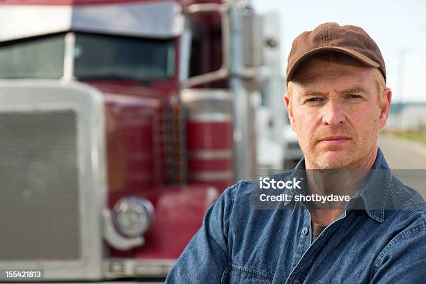 Red Truck And Driver Stock Photo - Download Image Now - Truck Driver, Serious, Blue-collar Worker