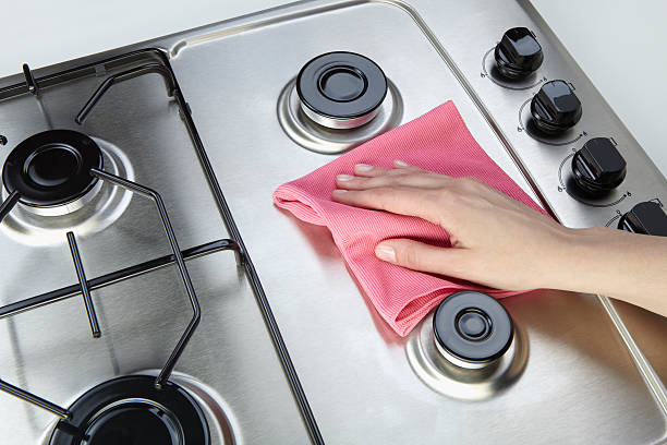 Cleaning set-top stove The woman cleaning set-top stove with rag microfiber stock pictures, royalty-free photos & images