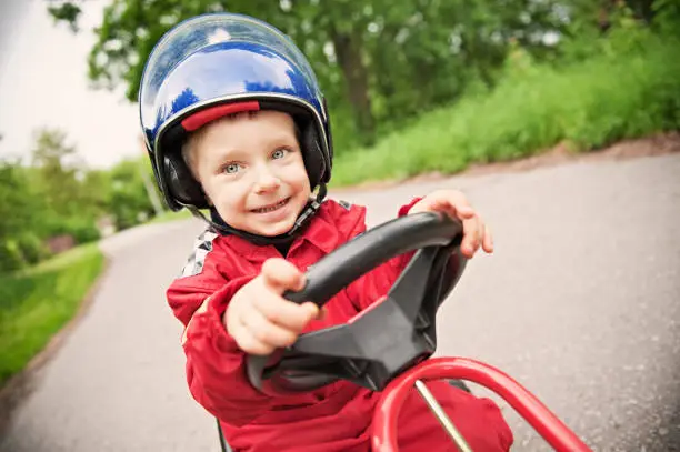 Little boy driving a go-kart. 