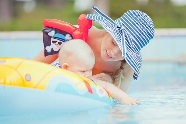 istock happy boy with mom in swimmingpool 155422299