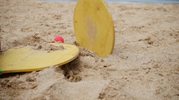istock Bat and wooden ball n a beach. 1554229373