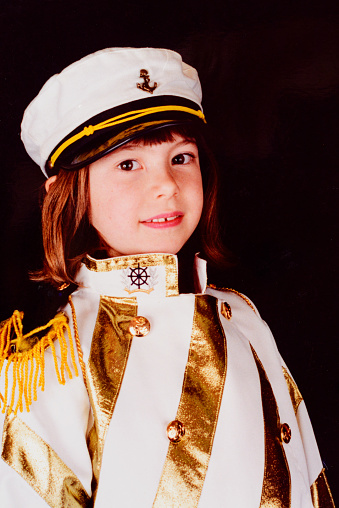 Vintage portrait of child dressed in sailor costume in photo studio in Brazil.