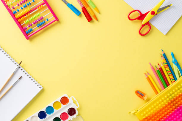 istock Discover the joy of education for small kids through this top view image: a captivating arrangement of vibrant school supplies on a sunny yellow surface, with copyspace for text or promotions 1554243704