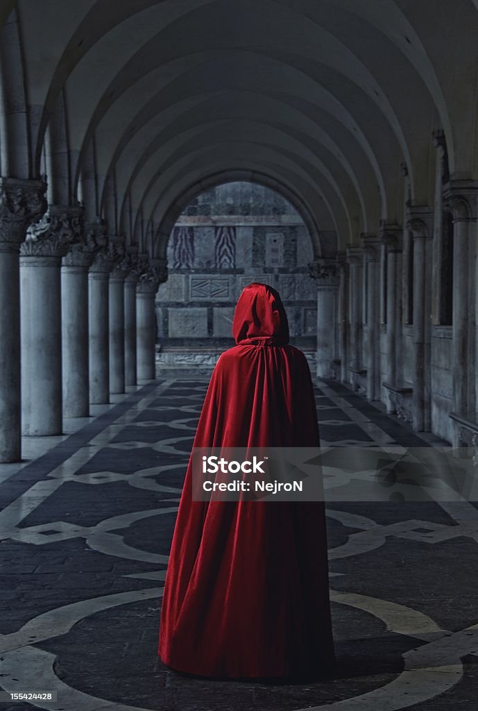 Woman in red cloak walking away Cape - Garment Stock Photo