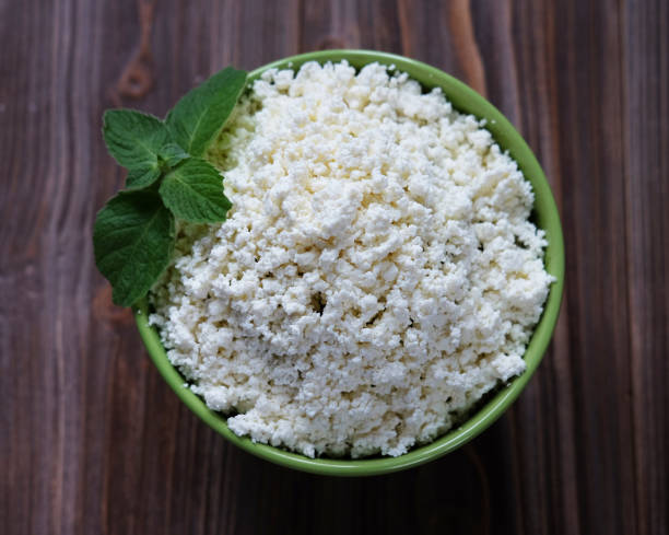 istock Cottage cheese in a bowl on a table. 1554250602