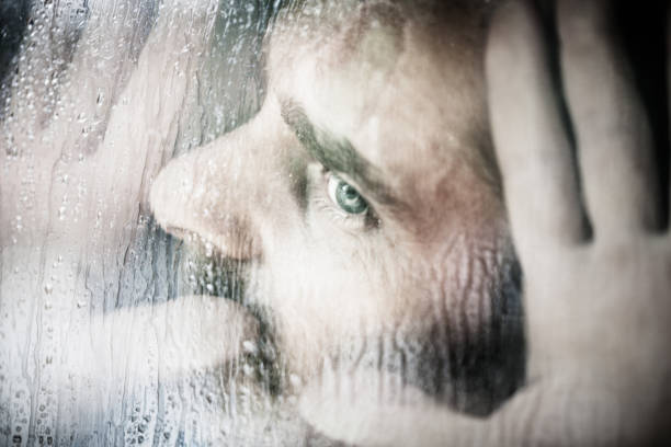 istock Man looks pressed against the Window, Rain 155427773