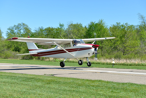 This is a Cessna Skyhawk single engine, piston-driven private airplane, landing at a small county airport.