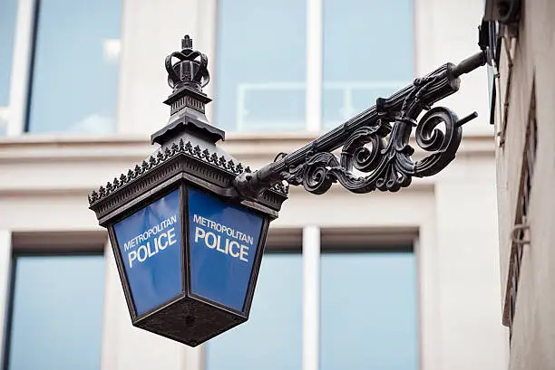 Close-up of a traditional police lantern, on display outside a police station in central London, England.