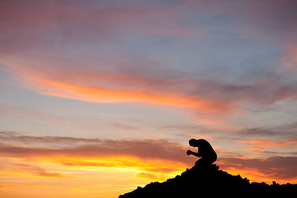 istock Silhouette of Man Praying 155428072