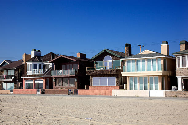 View from beach of houses owned and for rent as vacation spots on front of beach views in Newport Beach, California Orange County