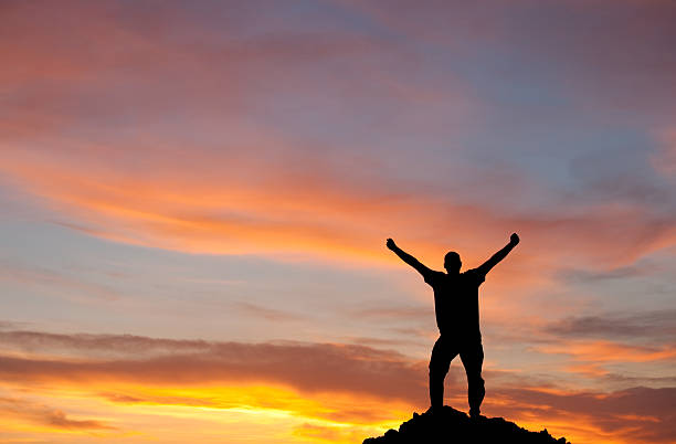 istock Silhouette of Man Lifting Arms in Joy 155428374