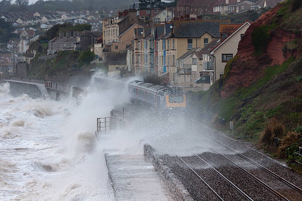 istock Intercity express with waves breaking over at Dawlish Devon 155428379