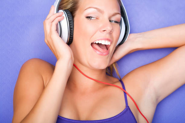 istock Young female listening to music while working out 155428808