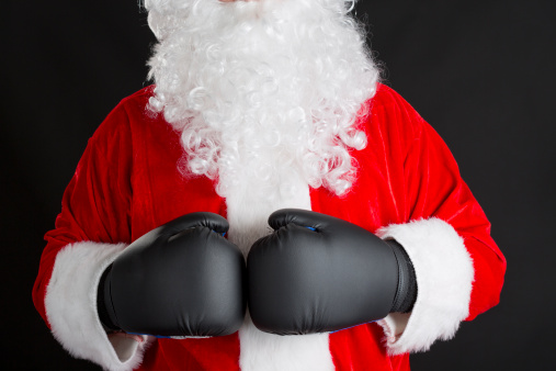 Santa Claus with black boxing gloves