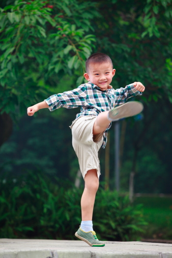 picture of one little boy kicking