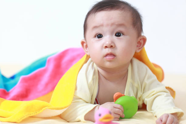 istock Cute asia baby on the bed 155429524