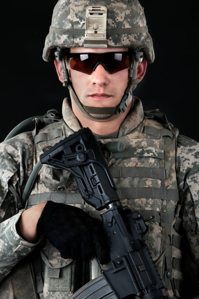 istock American soldier in combat universal camouflage uniform & helmet & weapon 155430025