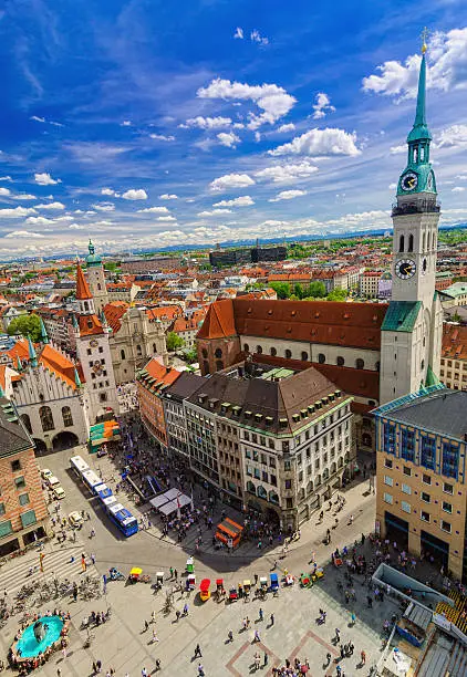 Birdseye view over Munich and the Marienplatz with the St Peters church on the right,the Heiliggeist church and the snow covered Alps in the far distance 