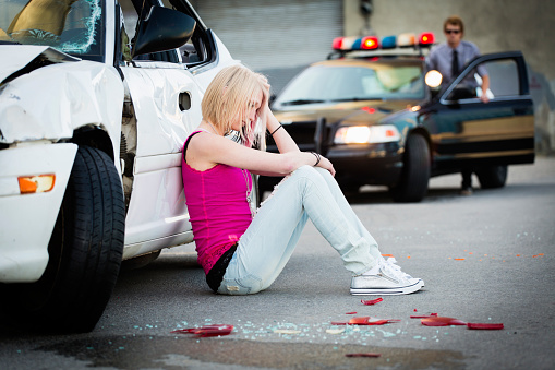 A police officer at a car accident scene.