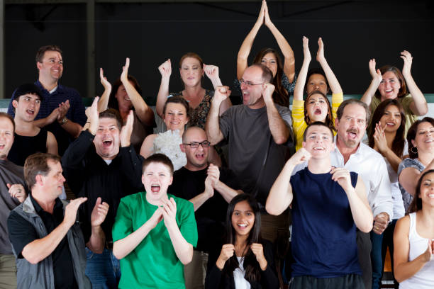 istock Diverse group of people standing and cheering at the game 155430526