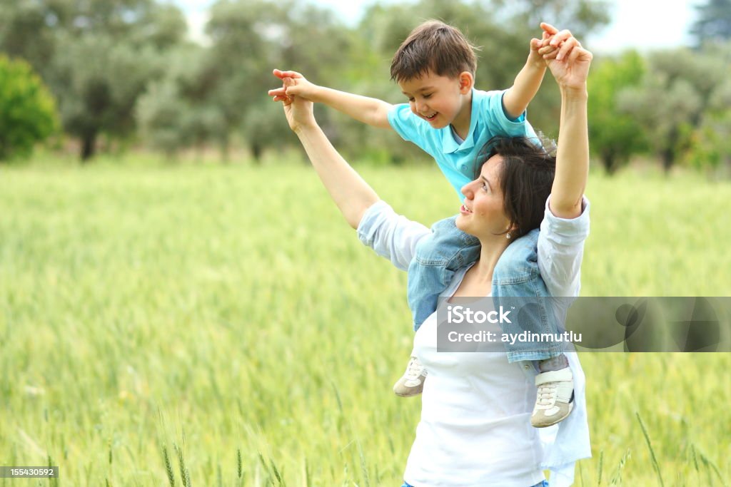 Madre e hijo relajarse juntos al aire libre - Foto de stock de A caballo libre de derechos