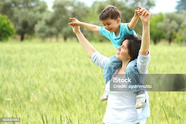 Mother And Son Relaxing Together Outdoor Stock Photo - Download Image Now - Adult, Affectionate, Arms Outstretched