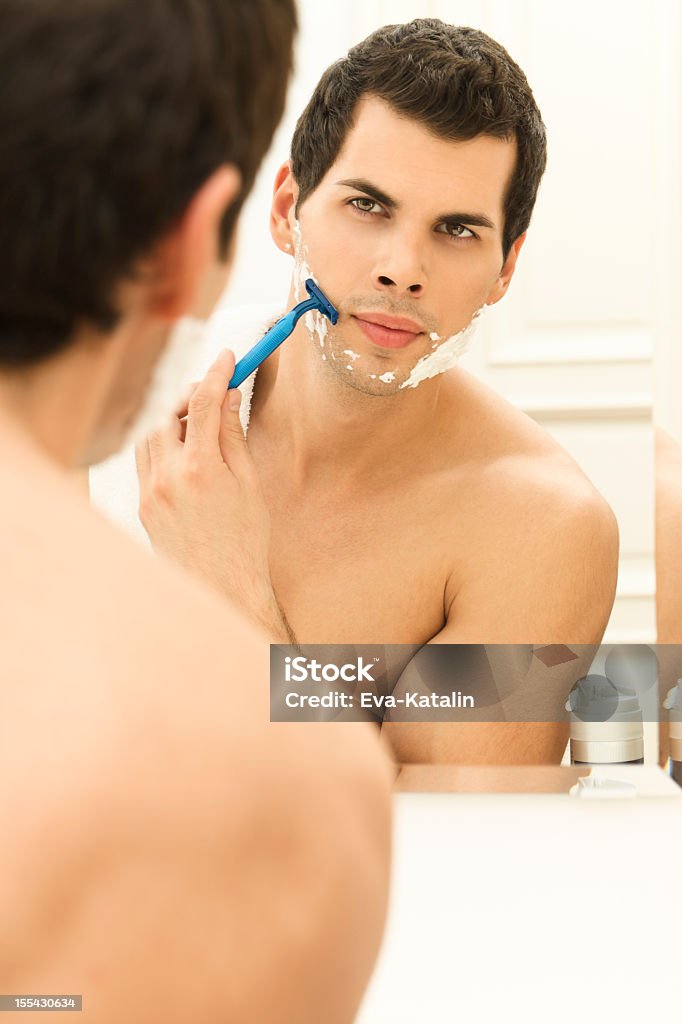 Young man shaving 20-29 Years Stock Photo