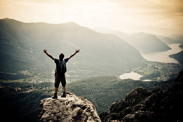 istock Man with arms outstretched on mountaintop 155430789