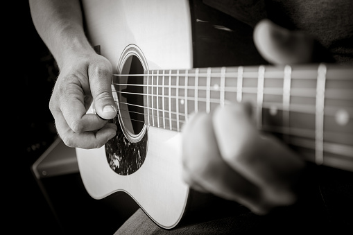 Acoustic Guitar Player close up with selective focus