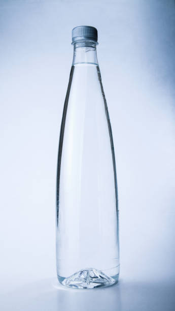 Glass bottle wet with cold water. External surface with drops of condensation water with the inscription \