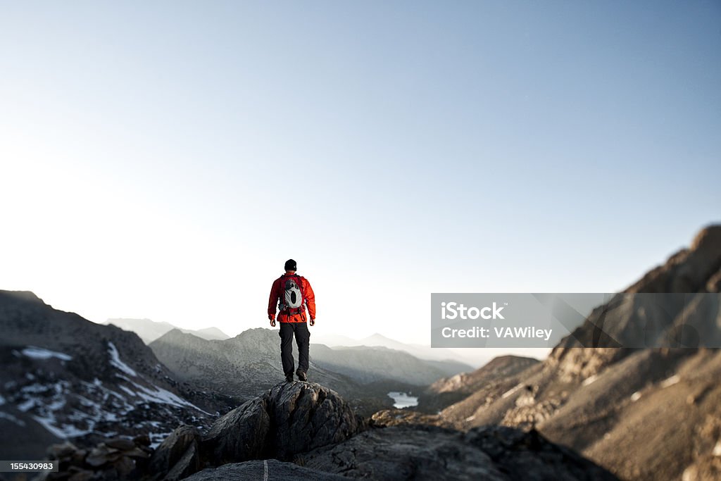 epic hiking A hiker looking on into the mountains.  Achievement Stock Photo