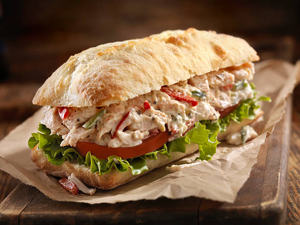 Chicken Salad Sandwich A Creamy Chicken Salad Sandwich with Red Peppers, Cucumber, Lettuce and Tomato on Ciabatta Bun - Photographed on Hasselblad H3D2-39mb Camera Mayo Chicken stock pictures, royalty-free photos & images