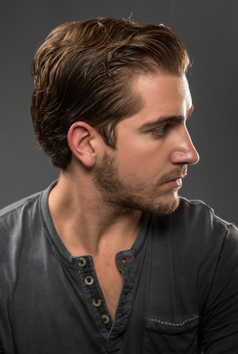 Serious young man (real people) profile on gray background