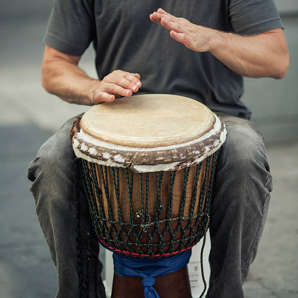 istock street percussionist playing african drum 155431567