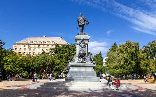 Punta Arenas, Chile - February 24, 2023: Plaza De Armas City Square with Treelined Paths, Benches and Memorial to Portuguese Explorer Ferdinand Magellan