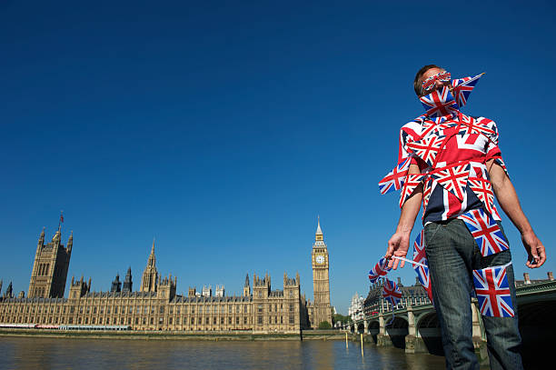 istock Union Jack Man Stands London Wrapped in British Flags 155431874
