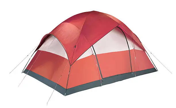 Photo of Red and white camping tent pitched to the ground