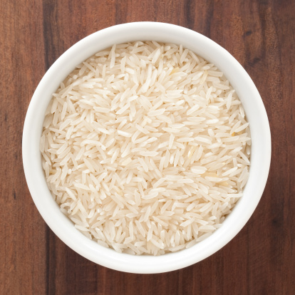 Top view of white bowl full of basmati rice