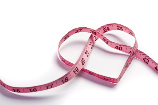 Measuring tape in the shape of a heart. Concept for healthy eating and fitness or measuring love or a ton of stuff I can't think of right now.