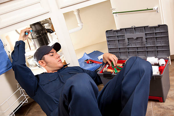 istock Plumber, repairman working under sink in home kitchen. 155432702