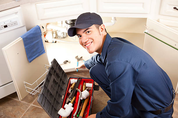 istock Latin descent plumber, repairman working under sink in home kitchen. 155432721