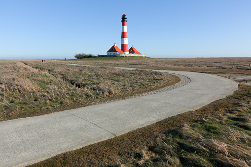 Westerhever Lighthouse with clear blue sky.